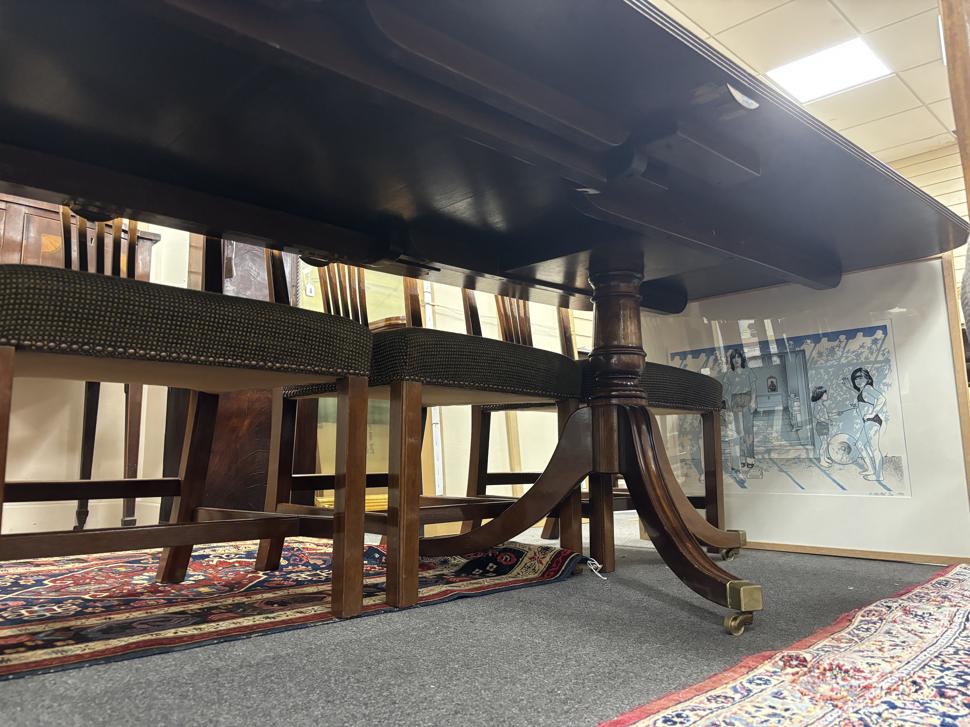 A reproduction George III style mahogany twin pillar extending dining table, 304cm extended, two spare leaves, depth 107cm, height 72cm